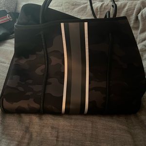 Black purse with gray and white striping and matching small bag.